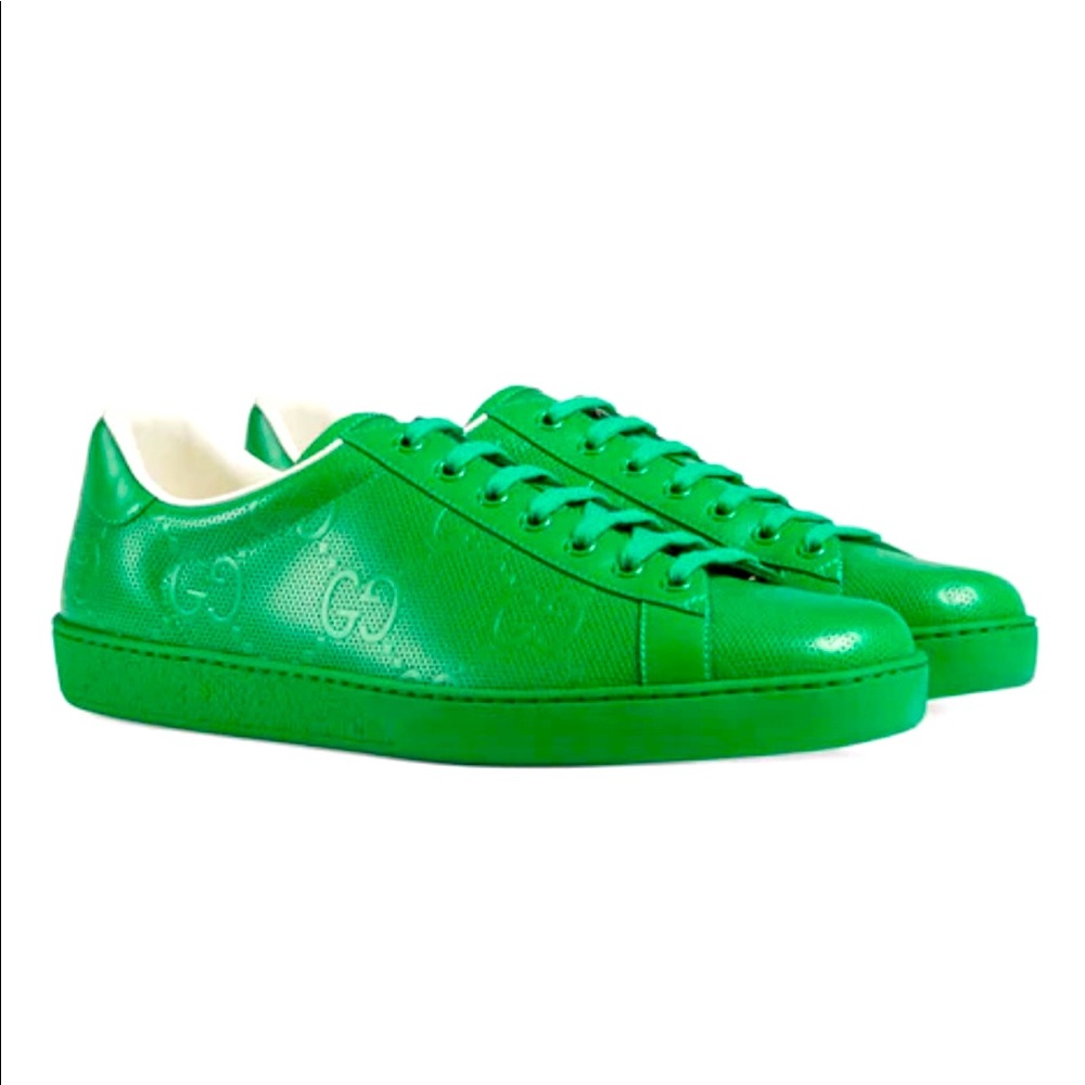 Men’s Gucci GG embossed green leather sneakers.